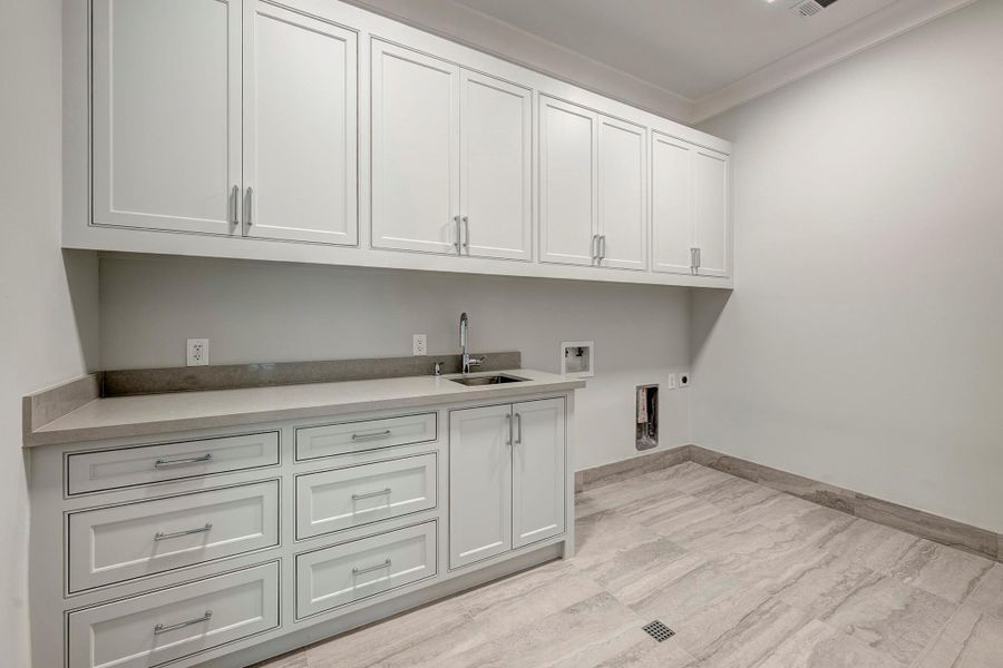 Large utility room on 2nd floor with folding counter and lots of storage. Large utility room on 2nd floor with folding counter and lots of storage.