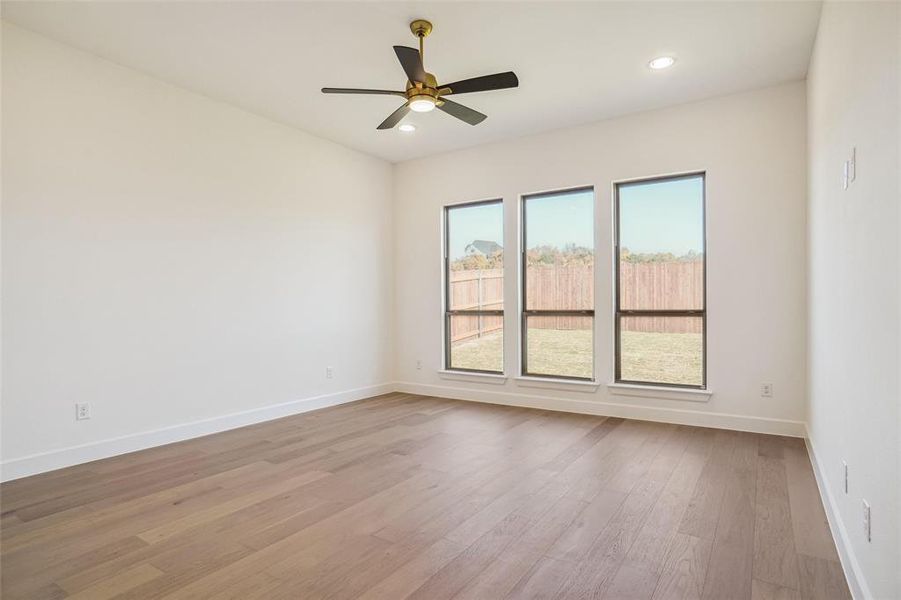 Spare room with ceiling fan and light hardwood / wood-style flooring