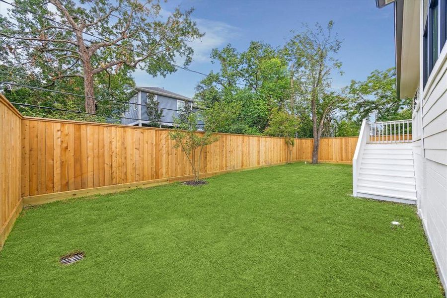 The spacious back lawn offers ample room for a future playset or pool. Imagine enjoying evenings and afternoons in this versatile space, brimming with potential for countless activities.