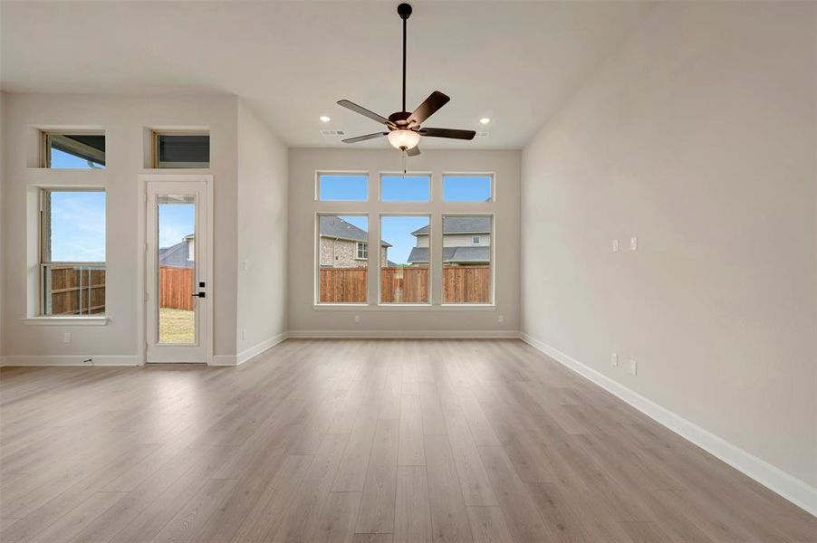 Spare room featuring light wood-type flooring, ceiling fan, and recessed lighting
