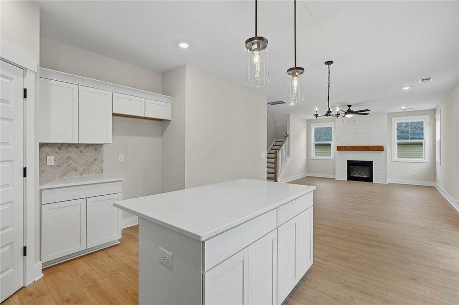 An open-concept layout connects the kitchen work a