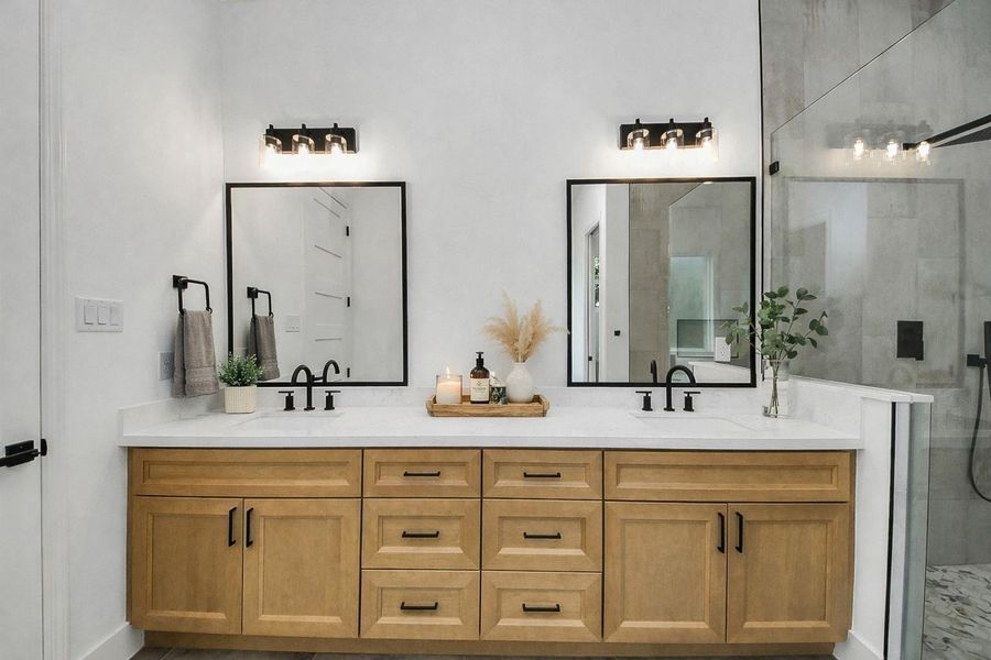 Elegant primary bathroom featuring a double vanity with ample storage, modern fixtures, and a clean, spa-like design. Bright and functional layout creates a relaxing space for everyday comfort.