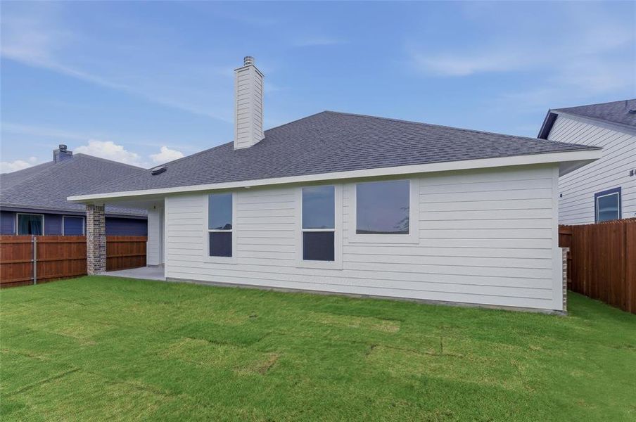 White horizontal siding exterior with a dark shingle roof, featuring a tall chimney and multiple windows White horizontal siding exterior with a dark shingle roof, featuring a tall chimney and multiple windows