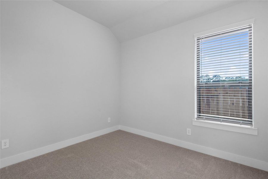 This cozy secondary bedroom offers plush soft carpeting, neutral walls ready for personalization, a sun-filled window with fitted blinds, sloped ceilings, and a spacious closet for all your storage needs. This cozy secondary bedroom offers plush soft carpeting, neutral walls ready for personalization, a sun-filled window with fitted blinds, sloped ceilings, and a spacious closet for all your storage needs.