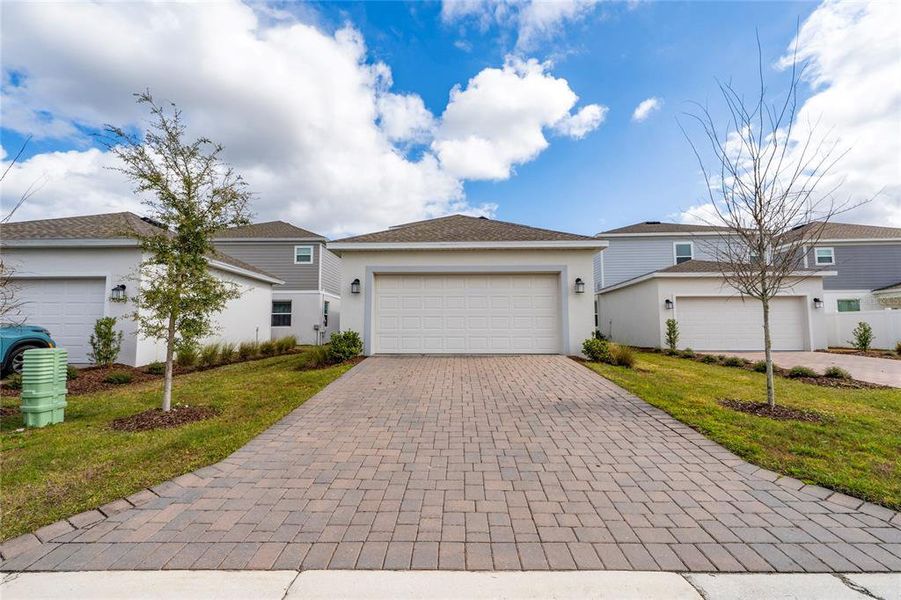 Front exterior of a new home in Bridgewalk, St. Cloud, FL, highlighting curb appeal (Image 20). Front exterior of a new home in Bridgewalk, St. Cloud, FL, highlighting curb appeal (Image 20).