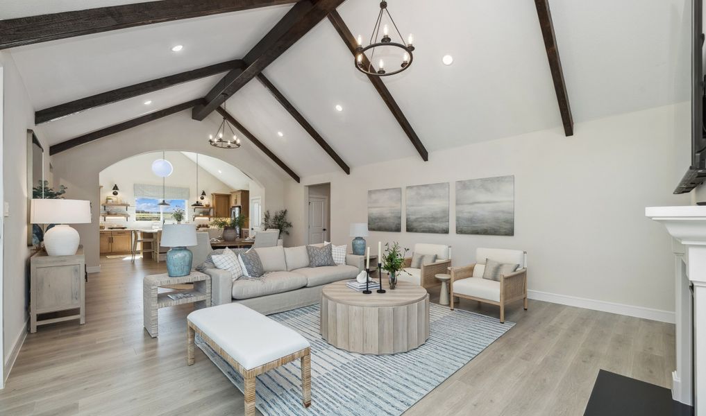 Great room with stained ceiling beams and chandelier