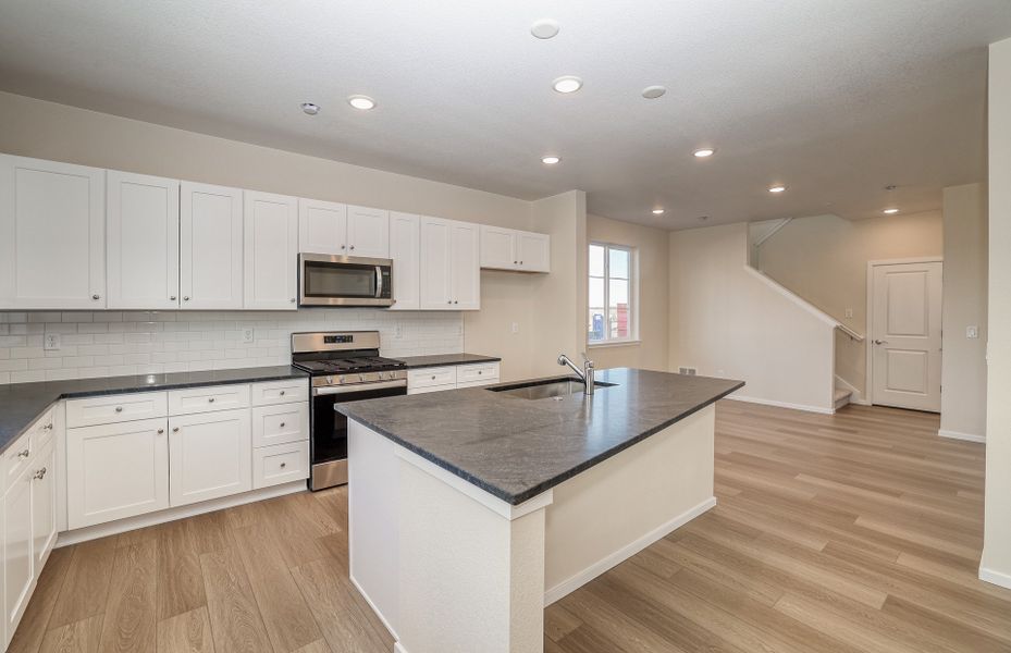 Spacious Kitchen with black granite countertops