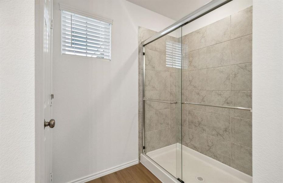 Spacious owner's suite bathroom with oversized shower*real home pictured