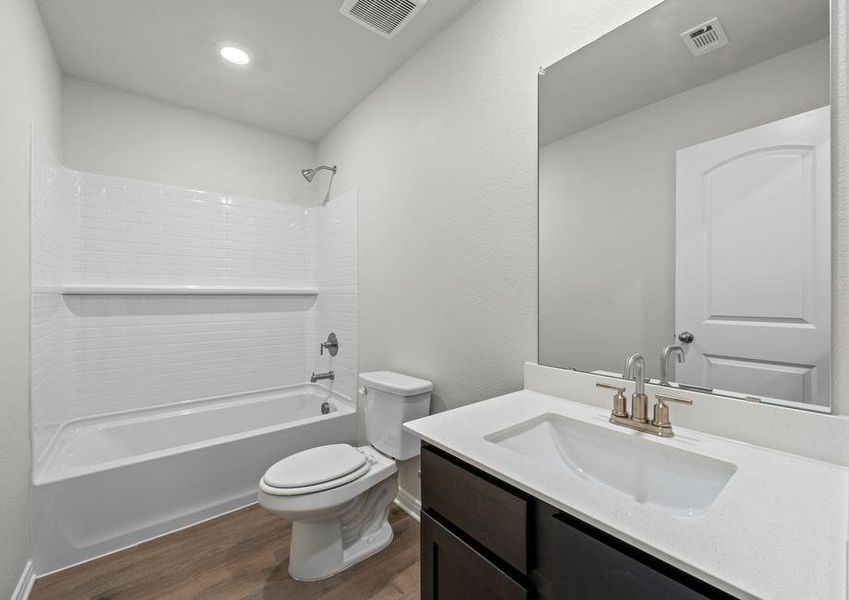 The secondary bathroom of the Cedar has a spacious vanity and shower-tub combo.