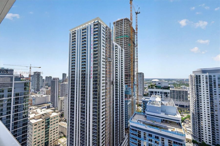 High-rise urban architecture featuring floor-to-ceiling glass paneling, balconies, and extensive exterior glazing