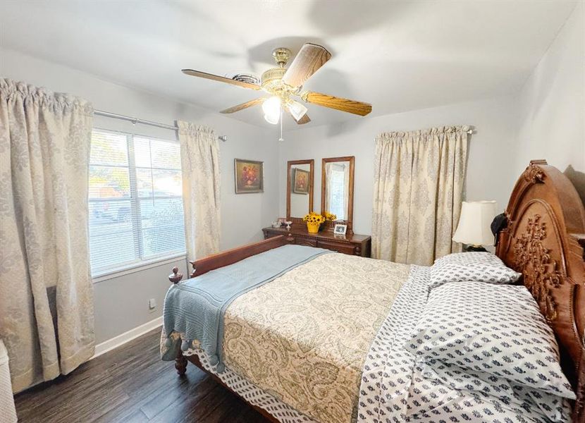 Bedroom with dark wood-style flooring and ceiling fan