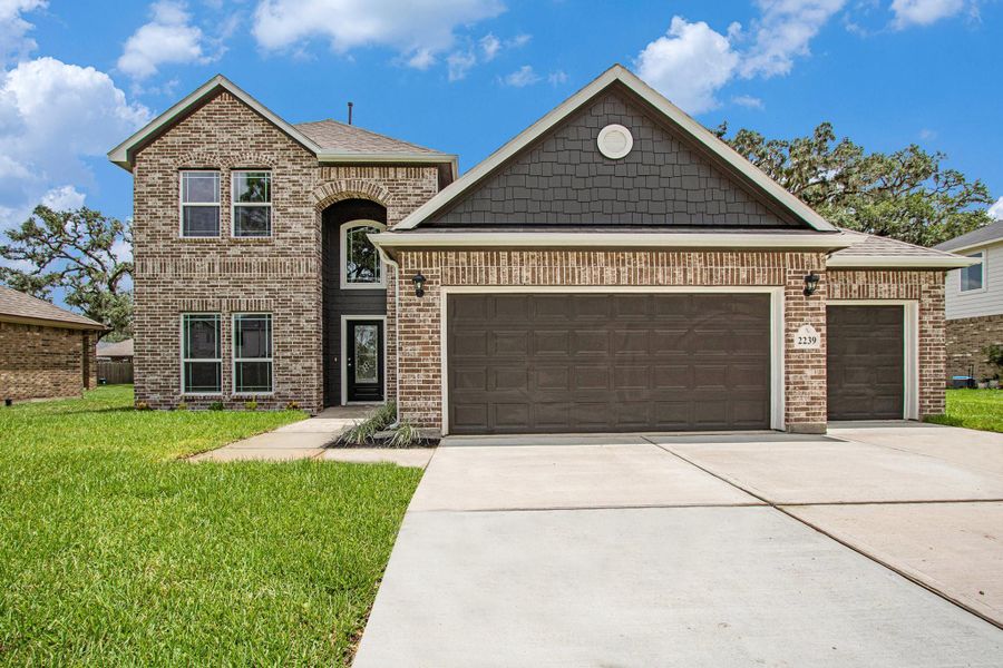 Front exterior of a new home in Columbia Lakes, West Columbia, TX, highlighting curb appeal (Image 1). Front exterior of a new home in Columbia Lakes, West Columbia, TX, highlighting curb appeal (Image 1).