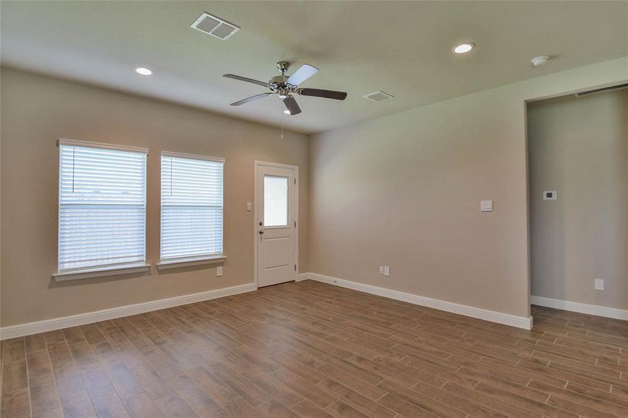 Spare room with a ceiling fan, wood finished floors, and recessed lighting Spare room with a ceiling fan, wood finished floors, and recessed lighting