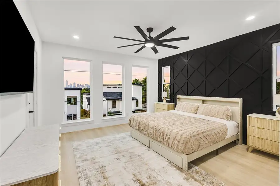 Bedroom with an accent wall, recessed lighting, light wood-style flooring, and a ceiling fan