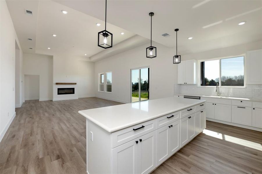 Kitchen featuring light wood finished floors, tasteful backsplash, and recessed lighting