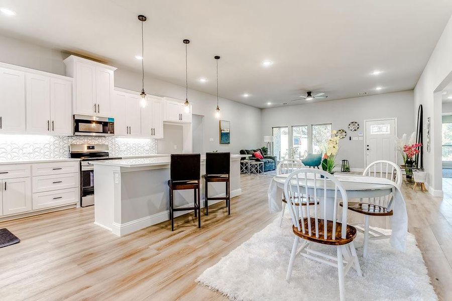 Dining area featuring ceiling fan and light wood-type flooring