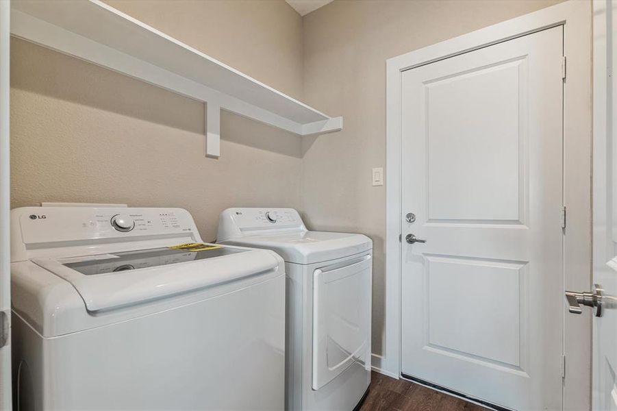 Clothes washing area featuring dark hardwood / wood-style flooring and washer and clothes dryer Clothes washing area featuring dark hardwood / wood-style flooring and washer and clothes dryer