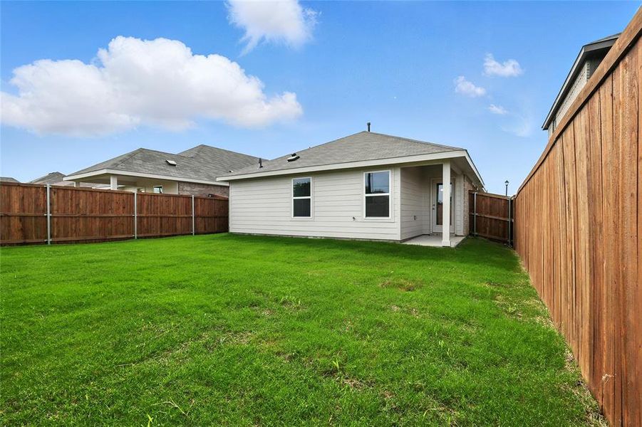 Rear view of house with a fenced backyard Rear view of house with a fenced backyard