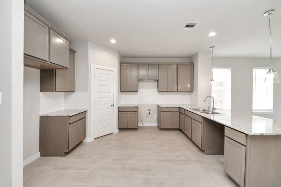 This generously spacious kitchen is a dream realized! Sample photo of completed home with similar floor plan. Actual colors and selections may vary.