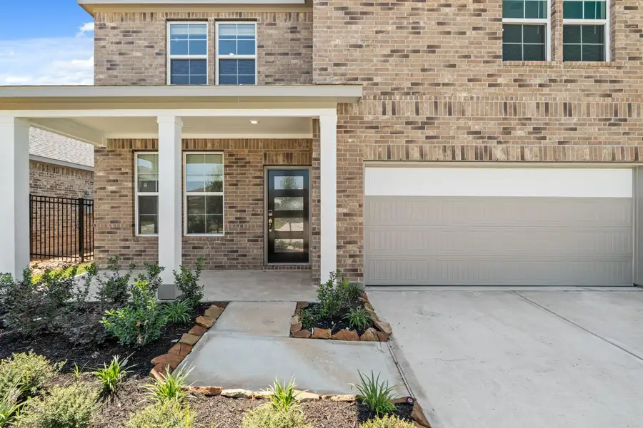 Front exterior of a new home in Sunterra, Katy, TX, highlighting curb appeal (Image 13). Front exterior of a new home in Sunterra, Katy, TX, highlighting curb appeal (Image 13).