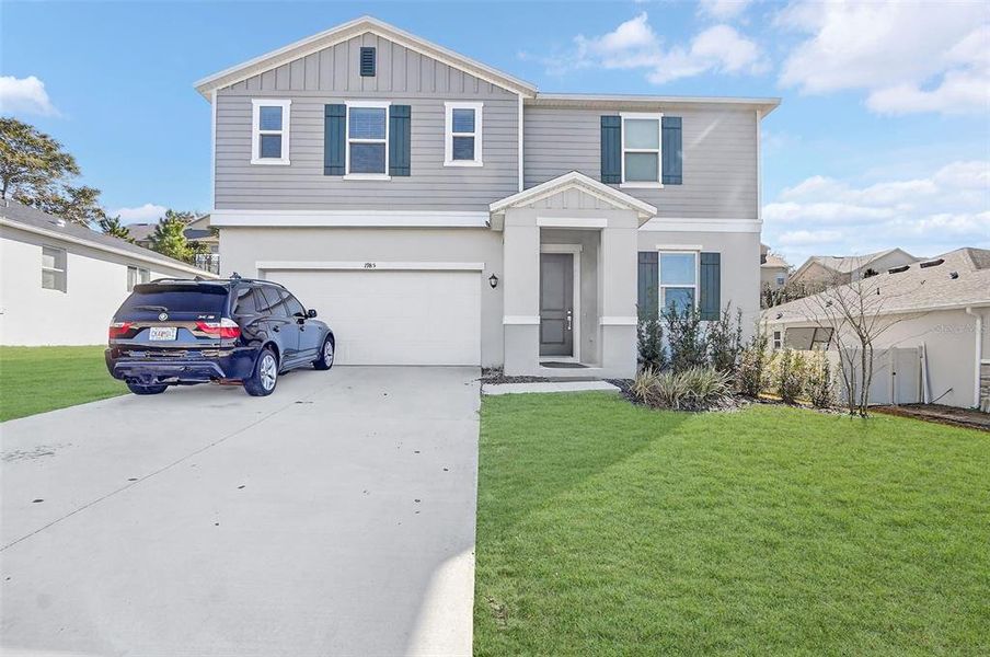 Front exterior of a new home in The Reserve at Lake Ridge, Minneola, FL, highlighting curb appeal (Image 22).