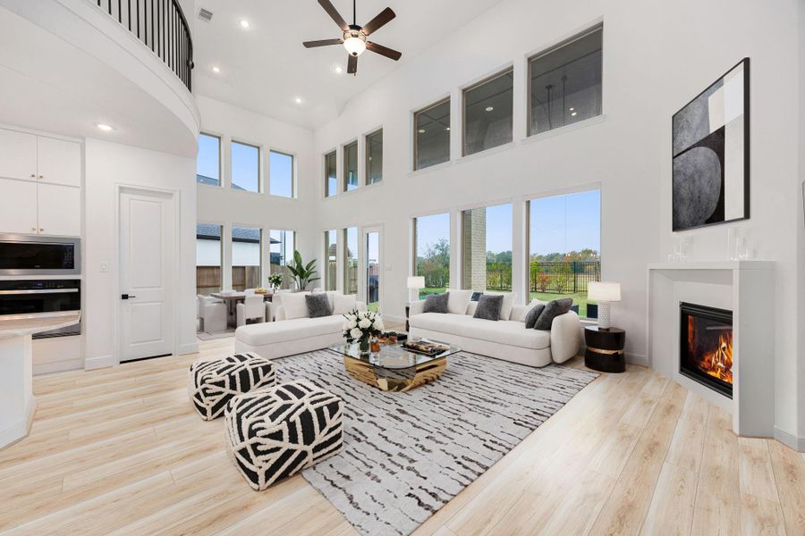 Soaring ceilings and expansive windows highlight the open-concept living area, creating a bright and airy atmosphere.