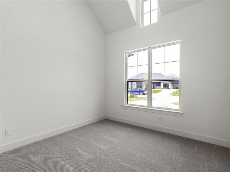 Carpeted empty room with plenty of natural light Carpeted empty room with plenty of natural light
