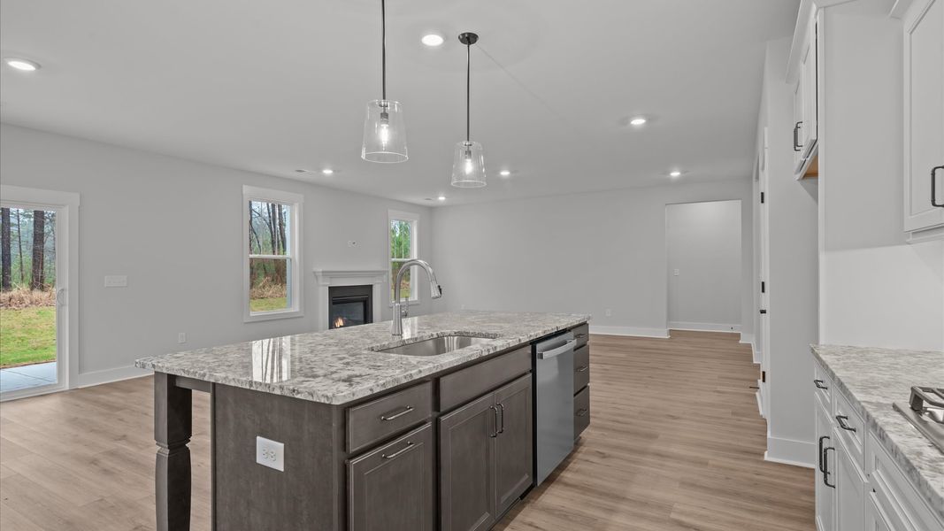Top-notch kitchen featuring pendant lighting over a statement 9-foot island with seating
