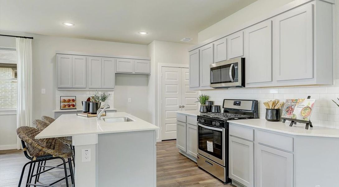 Kitchen in the Oak home plan by Trophy Signature Homes – REPRESENTATIVE PHOTO