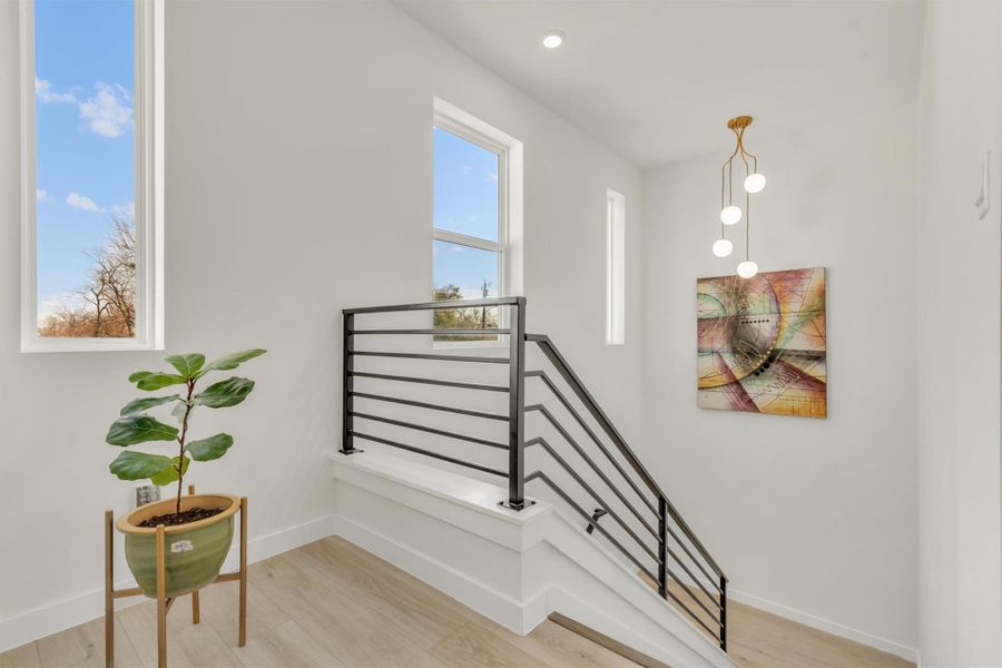 Stairs with baseboards and wood finished floors