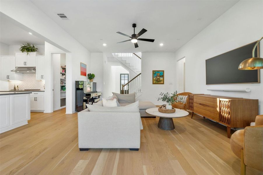 Step inside to discover a sunlit open floor plan that seamlessly blends the living room and kitchen, creating a warm and inviting space for gathering and entertaining.