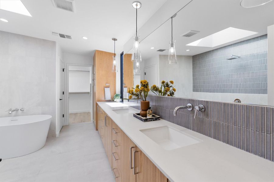 Primary bath complete with a soaker tub, rainforest shower, double vanity and privacy commode