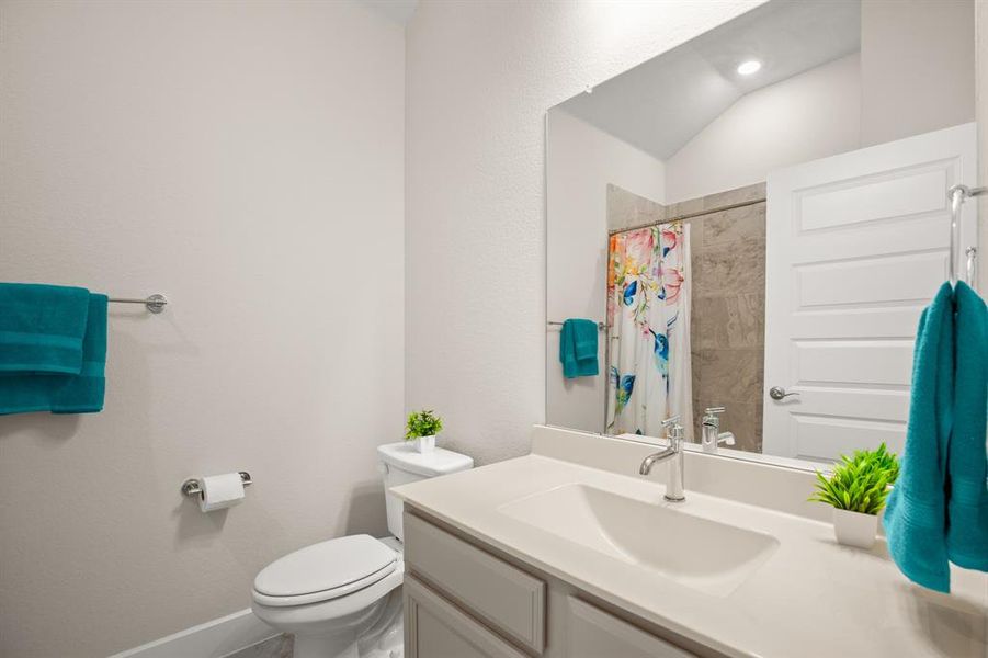 Step into the stylish guest bathroom, designed with modern fixtures and tasteful finishes to provide a comfortable and inviting space for guests.