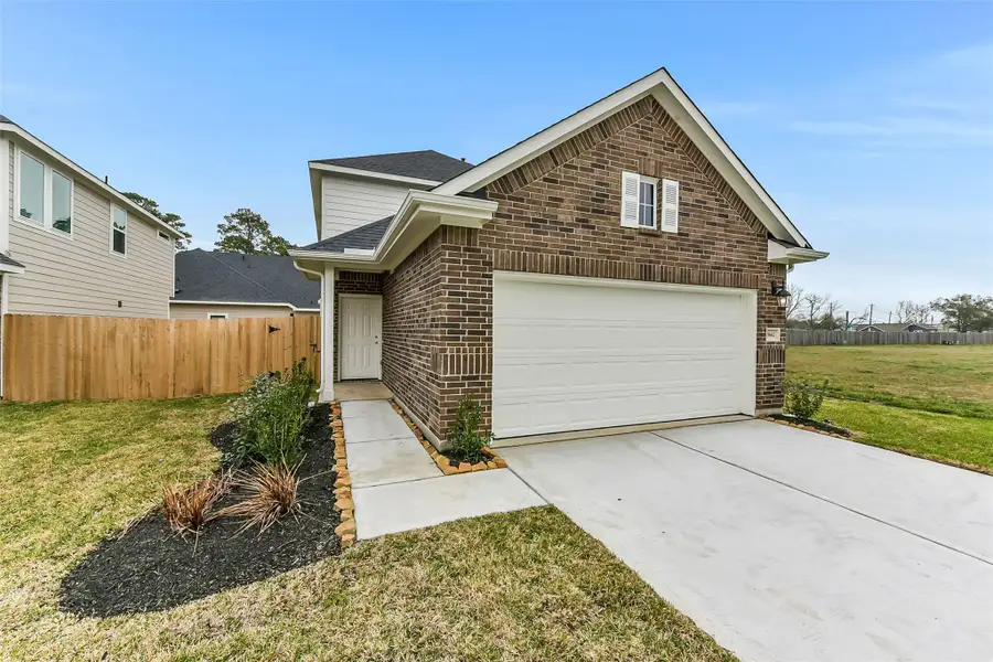 Front exterior of a new home in King Oaks Village, Baytown, TX, highlighting curb appeal (Image 1). Front exterior of a new home in King Oaks Village, Baytown, TX, highlighting curb appeal (Image 1).