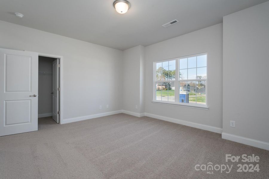 Main Level Secondary Bedroom with walk in closet.Photo representation. Colors and options will differ.