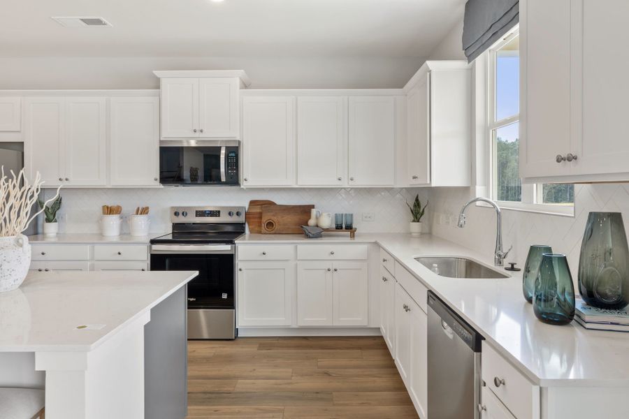 A kitchen with white cabinets. A kitchen with white cabinets.