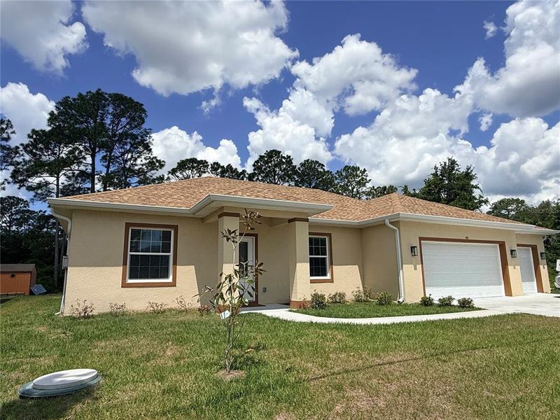Front exterior of a new home in , Palm Coast, FL, highlighting curb appeal (Image 30).