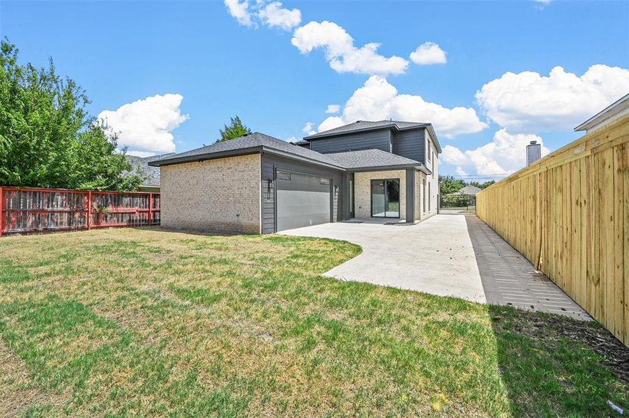 Rear view of property with a yard