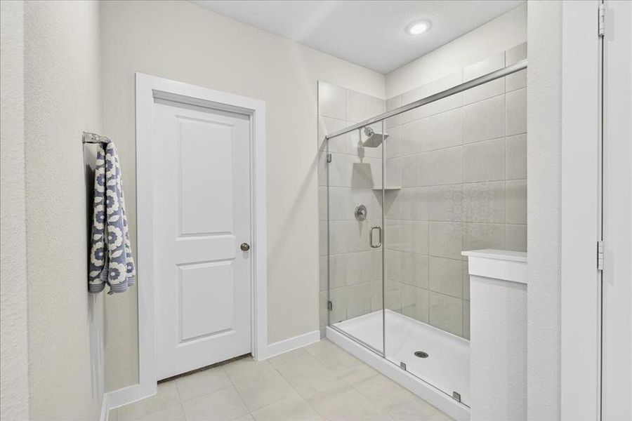 Primary bathroom with double sinks, lots of counter and storage space and large shower and walk in closet