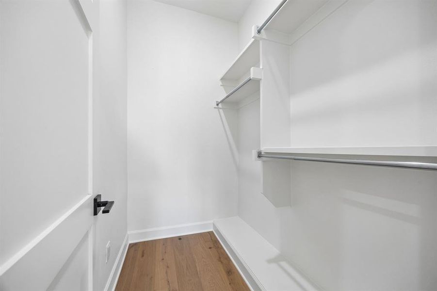 Walk in closet featuring wood finished floors Walk in closet featuring wood finished floors