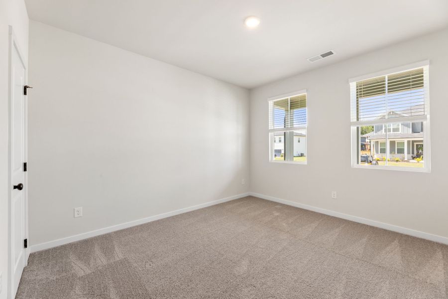 A room with windows and a carpet. A room with windows and a carpet.