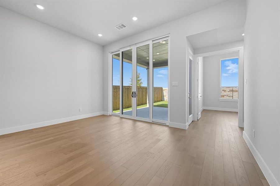 Unfurnished room with light wood-type flooring and recessed lighting Unfurnished room with light wood-type flooring and recessed lighting