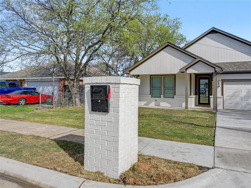 View of front of house with a garage, roof with shingles, and concrete driveway