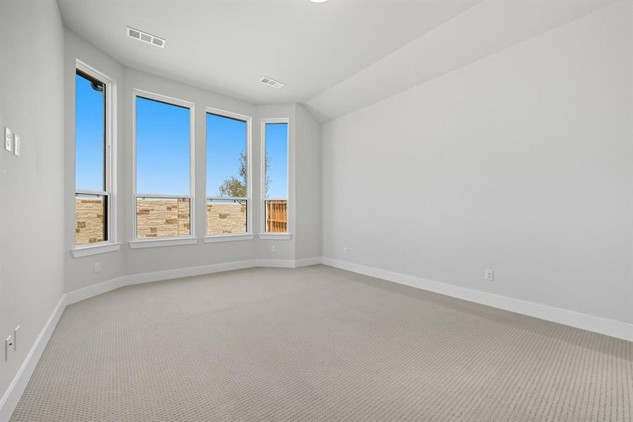 Spare room featuring carpet flooring and baseboards Spare room featuring carpet flooring and baseboards