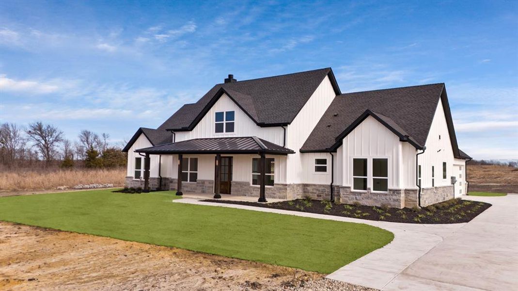 Modern farmhouse style home with a porch and a front yard