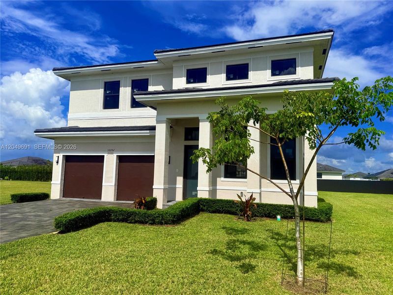 Front exterior of a new home in , Homestead, FL, highlighting curb appeal (Image 1). Front exterior of a new home in , Homestead, FL, highlighting curb appeal (Image 1).
