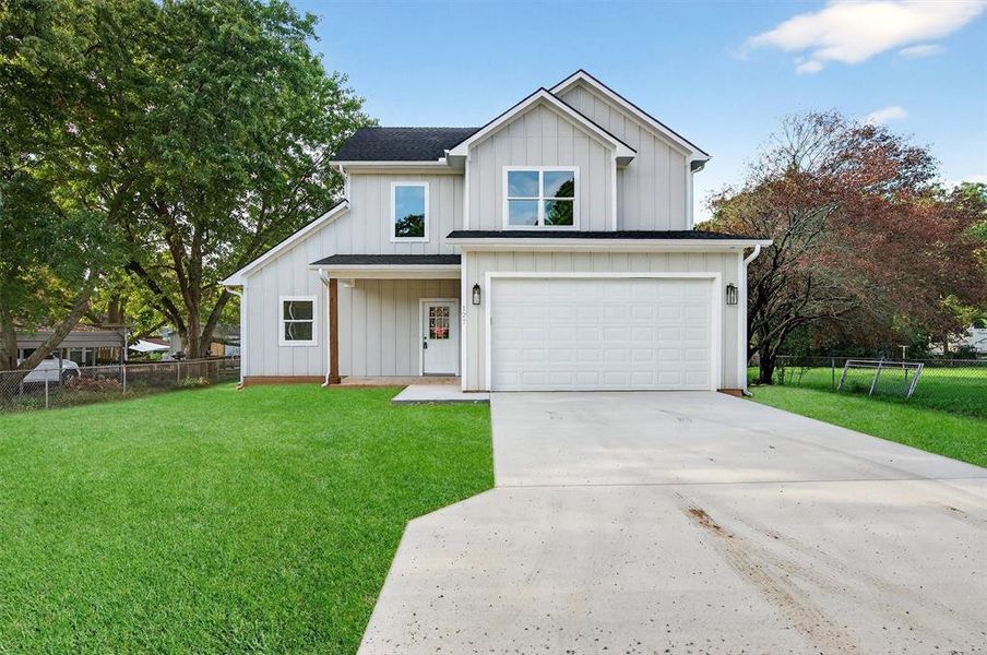Modern farmhouse with board and batten siding, concrete driveway, an attached garage, and covered porch Modern farmhouse with board and batten siding, concrete driveway, an attached garage, and covered porch