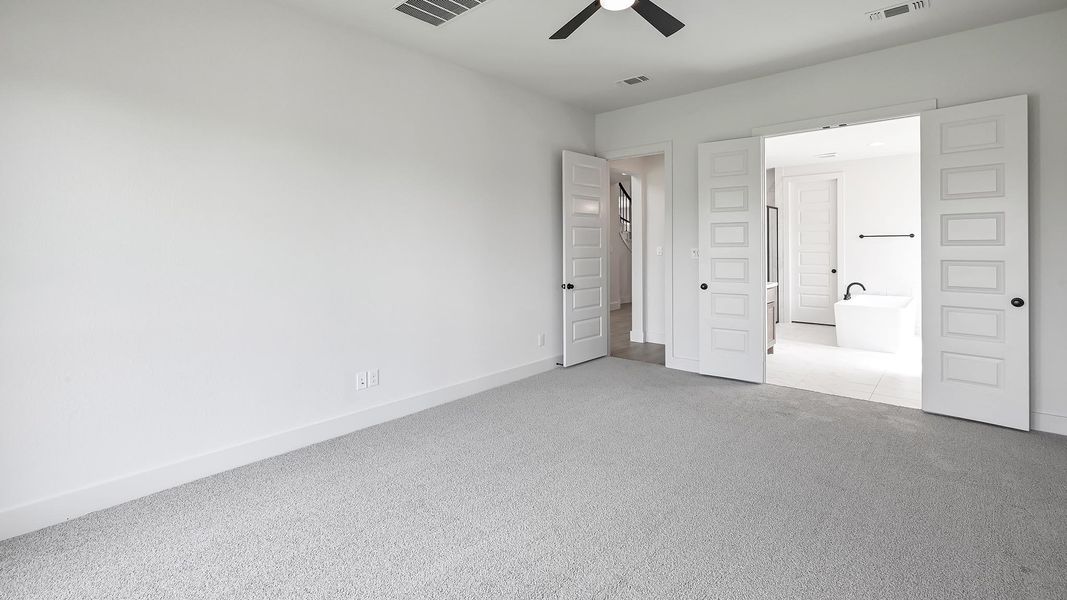 Unfurnished bedroom with carpet, baseboards, and a ceiling fan