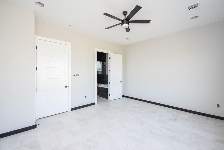 Primary Bedroom has lots of natural lighting showing entry to primary bath Primary Bedroom has lots of natural lighting showing entry to primary bath