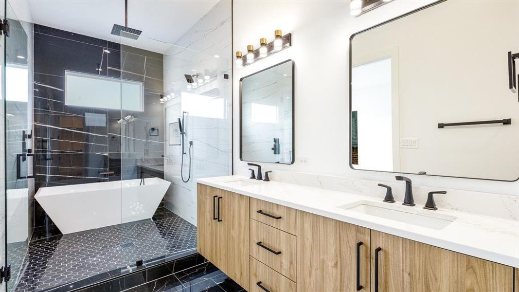 Bathroom featuring vanity and shower with separate bathtub